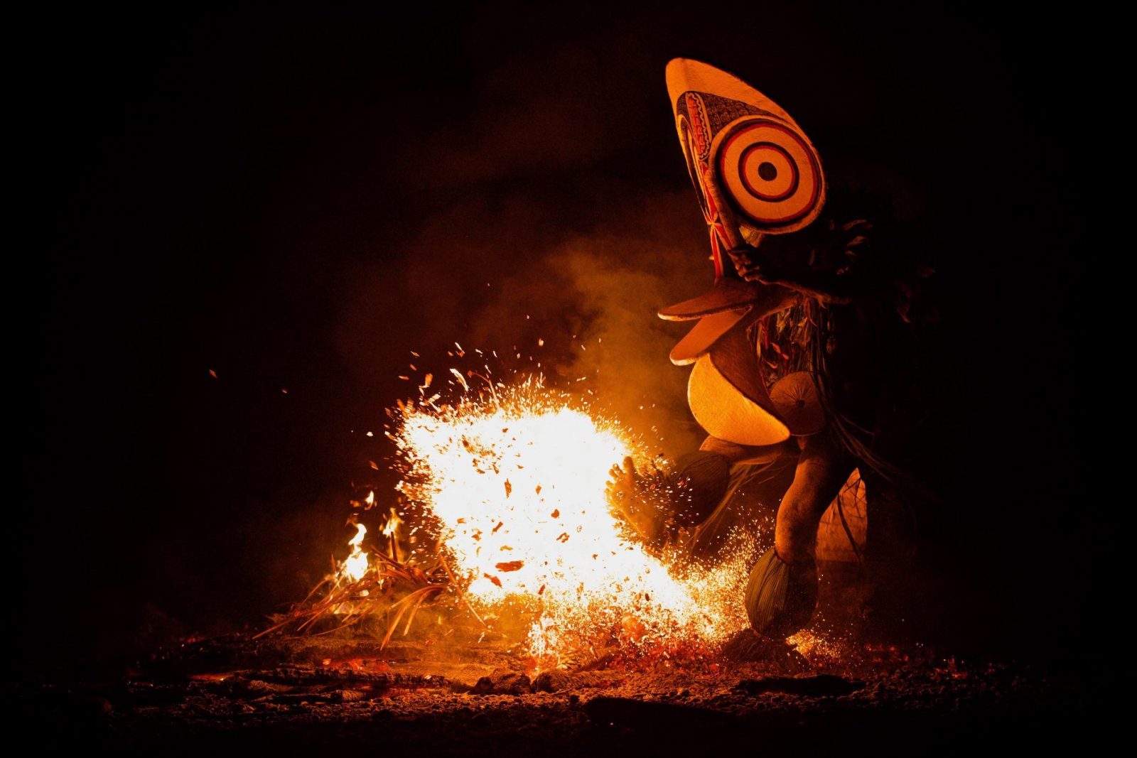 dancers kicking fire at the Fire Dance Festival in PNG