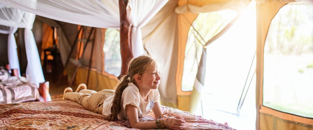Child in safari tent
